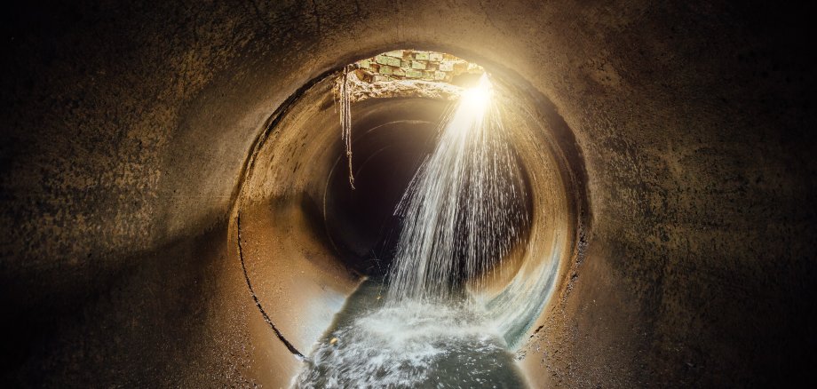 Flooded vaulted sewer tunnel with water reflection