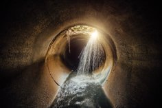Flooded vaulted sewer tunnel with water reflection Flooded vaulted sewer tunnel with water reflection
